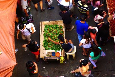 High angle view of woman selling lemons at market