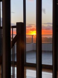 Scenic view of sea seen through window during sunset