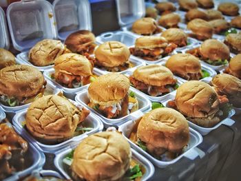 High angle view of burgers in containers on table