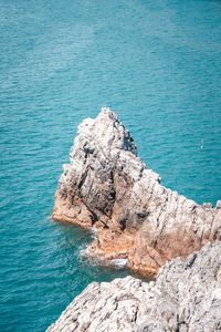 High angle view of rocks on sea