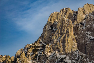 Low angle view of rock formations against sky