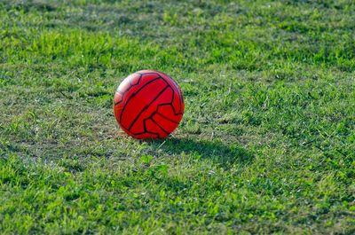 A red soccer ball in the ground