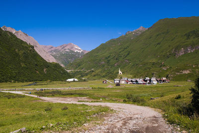 Scenic view of mountains against blue sky