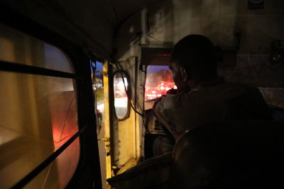 Rear view of man sitting in train