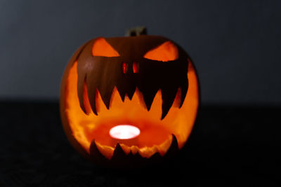 Close-up of illuminated pumpkin against black background