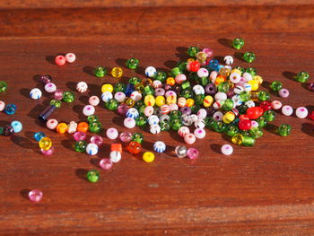 High angle view of colorful beads on table