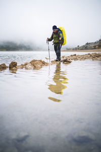 Full length of man standing in water