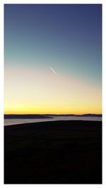 Scenic view of beach against sky during sunset