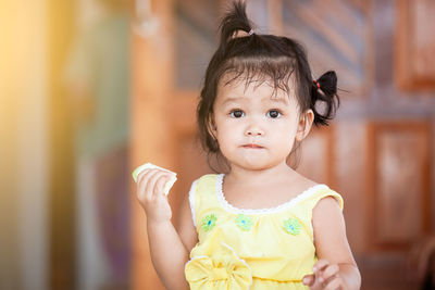 Close-up of cute baby girl eating fruit