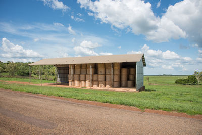 Built structure on field against sky