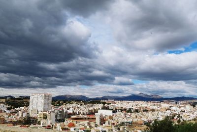 Cityscape against cloudy sky