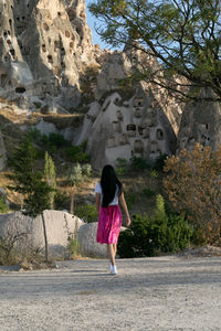 Rear view of woman standing on mountain