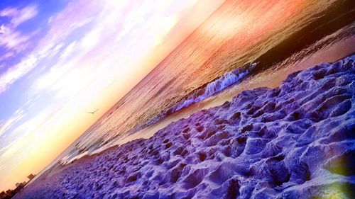 Scenic view of beach against sky during sunset