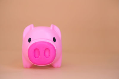 Close-up of pink candle against black background