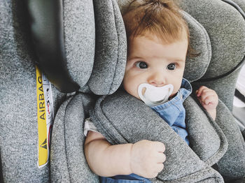 Portrait of cute baby on car seat