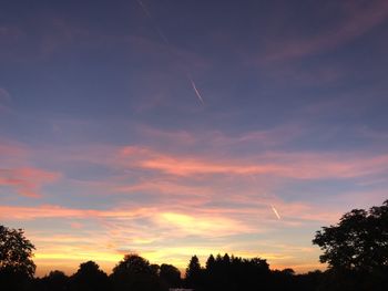 Low angle view of silhouette trees against sky during sunset