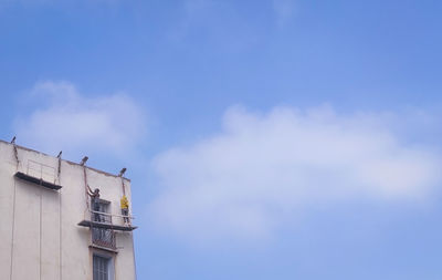 Low angle view of building against blue sky