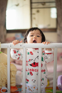 Portrait of cute baby girl at home