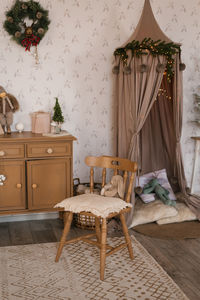 Cozy children's room decorated for christmas and new year. a chair and a canopy over the bed 