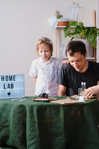 Father and son experimenting in the home laboratory and studying the chemical properties