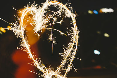 Close-up of illuminated fireworks against sky at night