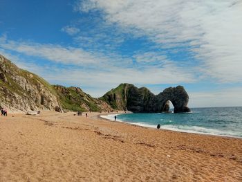 Scenic view of beach against blue sky