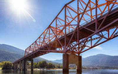 Low angle view of bridge over river against sky