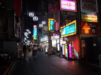 Illuminated city street and buildings at night