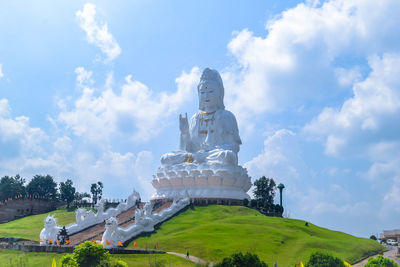 Low angle view of statue against cloudy sky