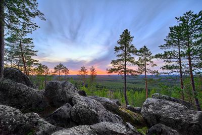 Scenic view of rocks against sky during sunset