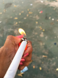 Close-up of hand holding cigarette