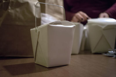 Midsection of woman packing boxes