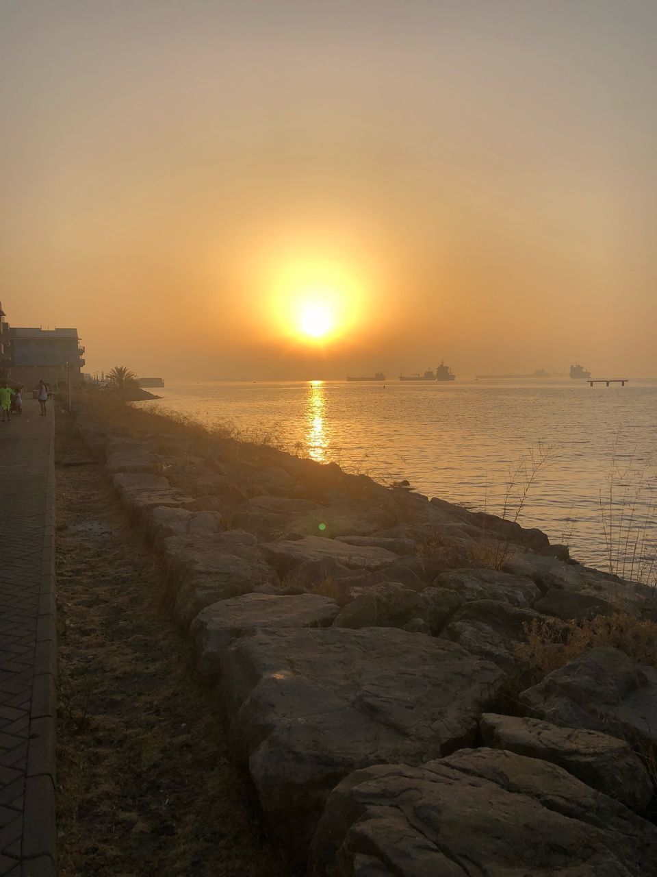 SCENIC VIEW OF SEA AGAINST ORANGE SKY