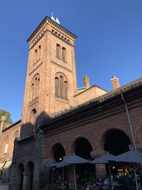 Low angle view of historic building against blue sky