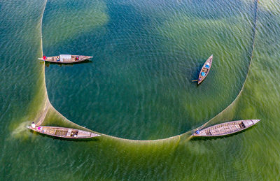 High angle view of boat with people in sea
