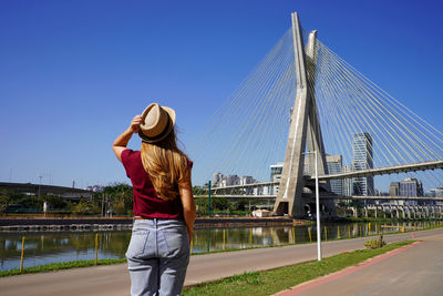 Back view of woman enjoying view of ponte estaiada bridge in sao paulo, brazil