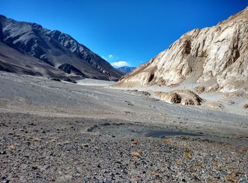 Scenic view of mountains against cloudy sky