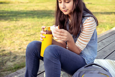 Portrait of young woman using mobile phone