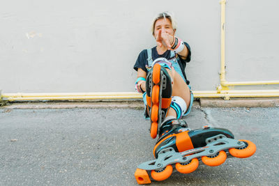 Holidays, sportive activities and hobby concept. young woman with roller skates riding outdoors.
