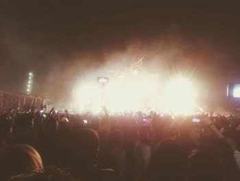 People enjoying music concert at night