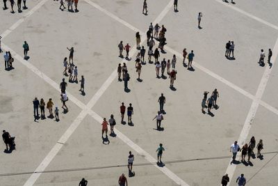 High angle view of people walking on road in city