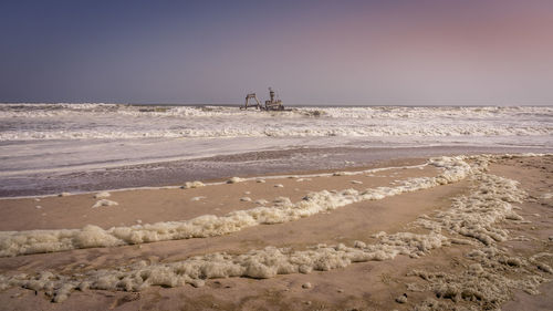 Scenic view of beach against clear sky