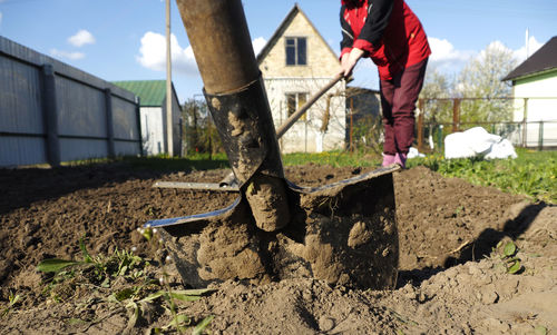 Low section of woman plowing back yard