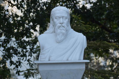 Low angle view of statue against trees