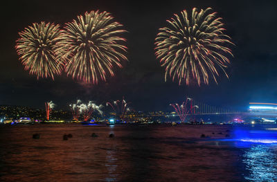 Low angle view of firework display at night