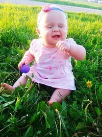 Cute baby girl on field