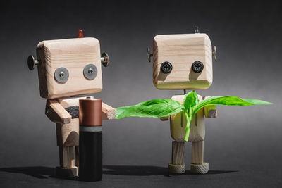 Close-up of toys on table against black background