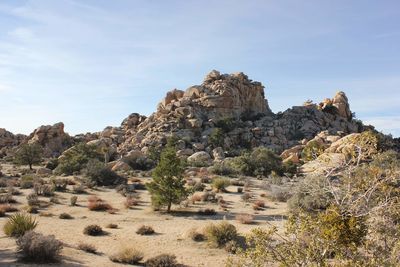 Rock formations on landscape against sky