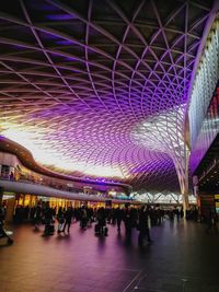 Group of people in illuminated modern building at night