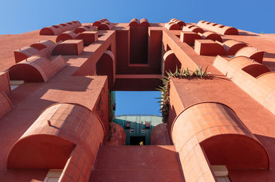 Low angle view of buildings against clear blue sky